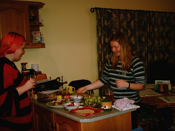 kathryn and stella inspect kevin's cooking.  this is the day before the party.