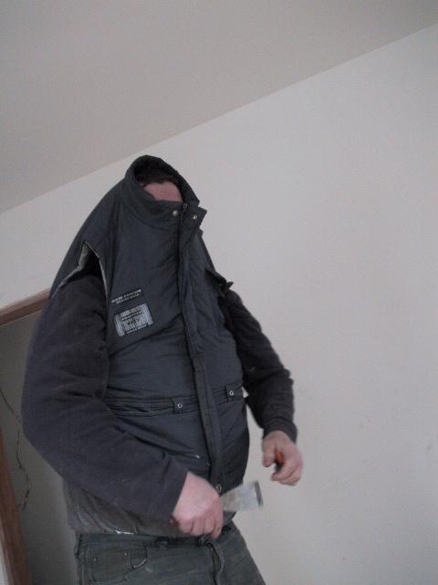 John models his coat.